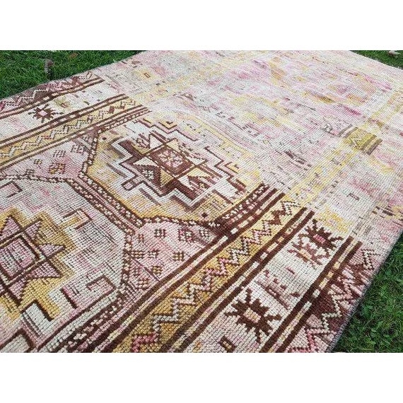 This is a vintage handwoven wool rug from turkey. The piece was made in the 1970s.