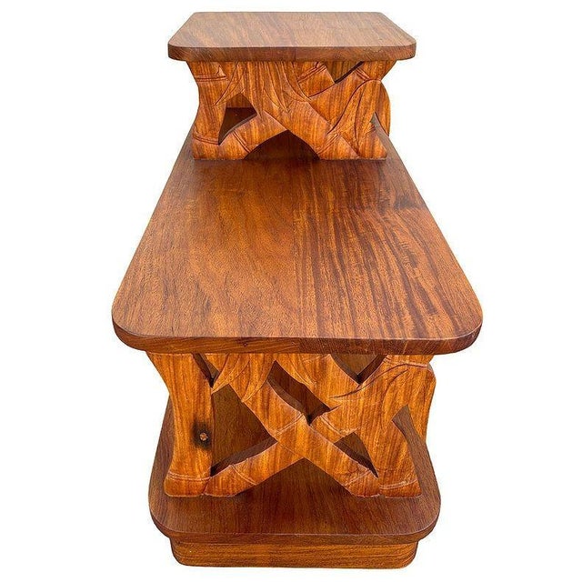 This beautifully restored 3-tiered side table is crafted from hand-carved koa wood featuring 2 front panels sculpted into...