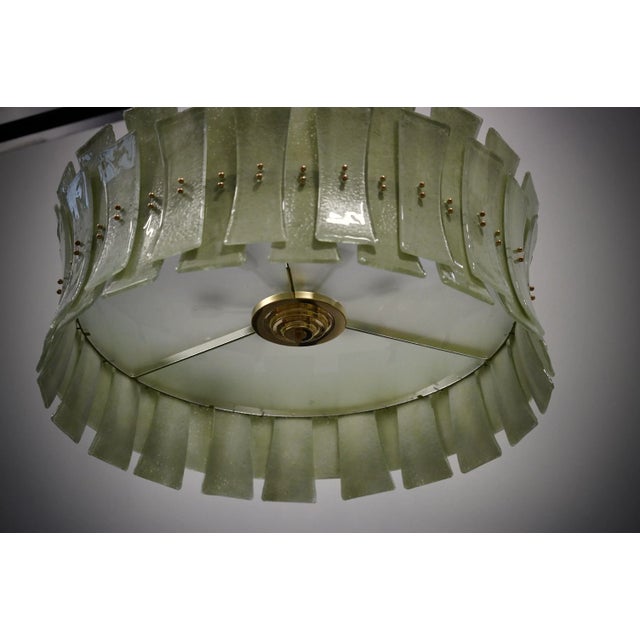 Fantastic round chandelier in Murano glass and polished brass. Note the shape of the green Murano glass tiles, very...