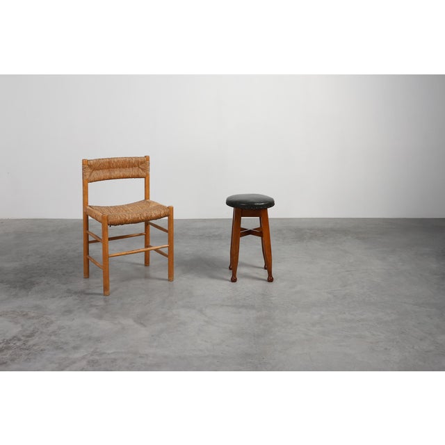 A beautifully honest piece of early 20th‑century French craftsmanship, this 1920 stool blends the tactile warmth of the...