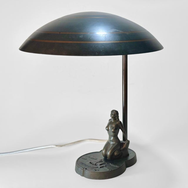 A sculptural Swedish Grace table lamp produced by Malmö Metallvarufabrik in the 1930s. Crafted from solid bronze with a...