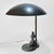 A sculptural Swedish Grace table lamp produced by Malmö Metallvarufabrik in the 1930s. Crafted from solid bronze with a...