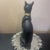 Black & Gold Ceramic 8.5” Egyptian Bastet Cat Sculpture The Black & Gold Ceramic 8.5” Egyptian Bastet Cat Sculpture is a...