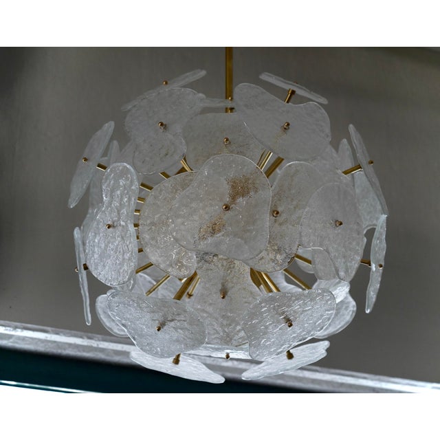 Large clear glass flowers compose this stunning Murano chandelier. A classic mid century Sputnik. It features a large...