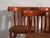 A set of four antique chairs in bentwood, with a curved crest rail over vertical splats and a moulded board seat....