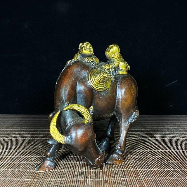 This is a charming vintage Chinese gilt bronze sculpture depicting two young herders riding on the back of a water...
