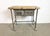 Vintage Industrial worktable from the 1960s. It features an iron construction with four original wheels, a solid wooden...