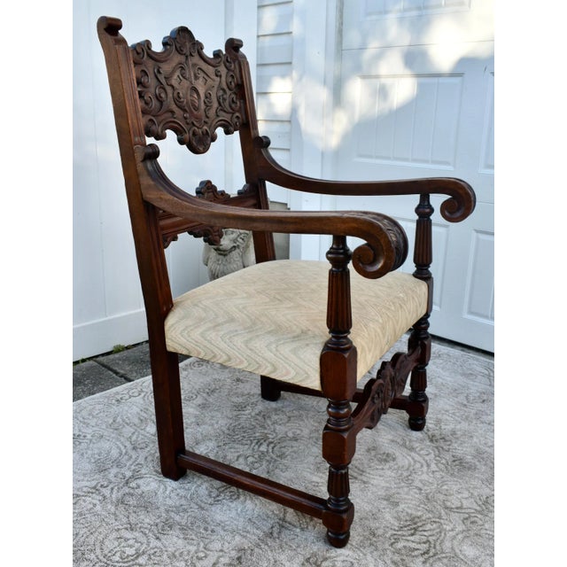 Antique - Circa 1900's Arm Chair has a Tudor Style. The Frame is Walnut. Ornately Carved Wood. Stretcher Base. Patterned...