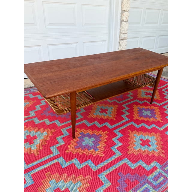 A gorgeous Danish teak coffee table with all the details we love — beautiful teak grain, long tapered legs and a fantastic...