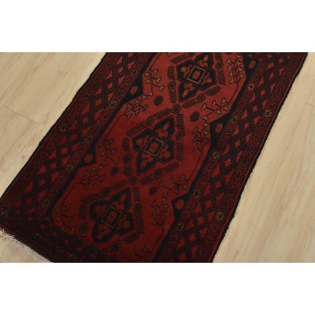 A tribal Turkmen rug hand-knotted with fine wool on a cotton foundation. This rug features geometric motifs set against a...