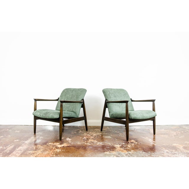 A pair of GFM-64 armchairs designed by Edmund Homa, produced by the Gościcińska Fabryka Mebli (GFM) in Poland during the...