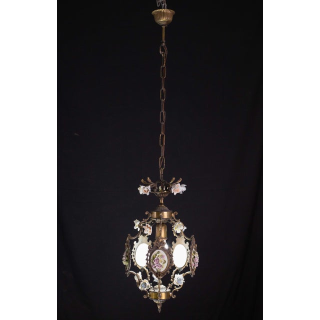 Gorgeous brass and ceramic chandelier in Art Nouveau style. Produced in Italy during the period 1960-1970. Decorated with...
