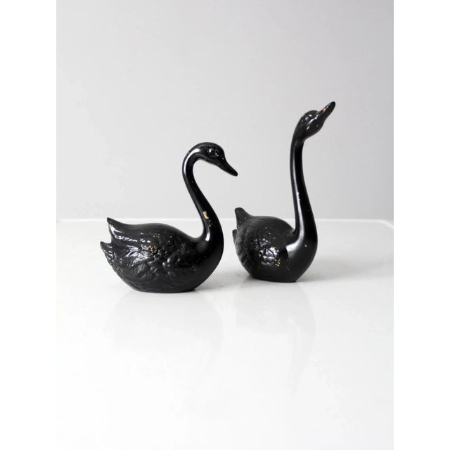 This is a pair of mid-century brass swans. Painted black, the brass figurines have sleek lines and lovely patina. 7.75" x...
