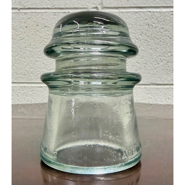 This is an antique Armstrong aqua glass electrical/telephone insulator, featuring thick molded glass construction and the...