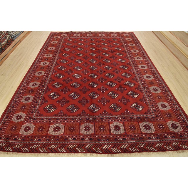 An authentic vintage tribal Turkmen rug hand-knotted with fine wool and natural dyes. This nomadic rug features rows of...