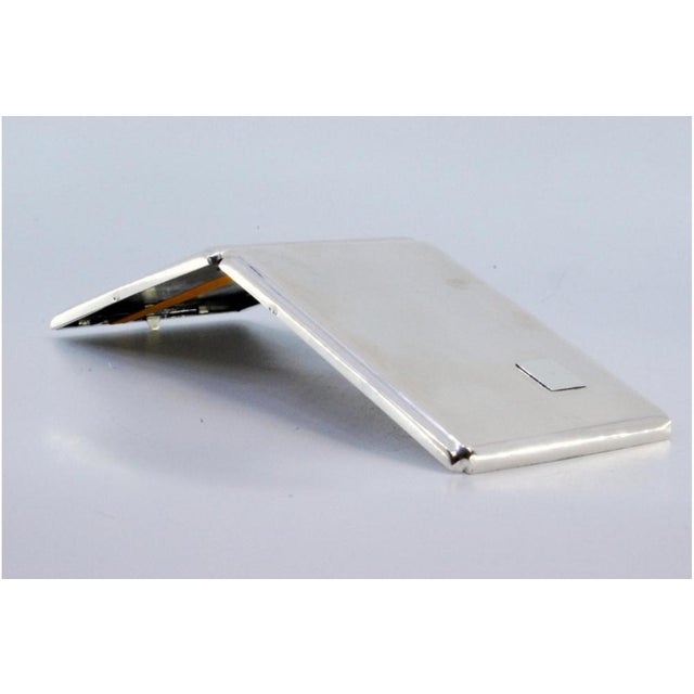 Plain Silver Cigarette Case with Monogram Card, in Very Good conditions. Designed 1920 to 1949 This piece has an...