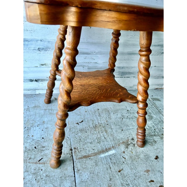 Vintage 1920's parlor table. Tiger wood, very heavy and sturdy. Hand spun legs with a small level at the bottom.