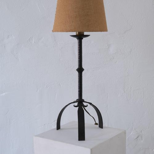 Brutalist wrought iron table lamp from the mid-century period, featuring a hand-forged tripod base and textured fabric...