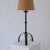 Brutalist wrought iron table lamp from the mid-century period, featuring a hand-forged tripod base and textured fabric...