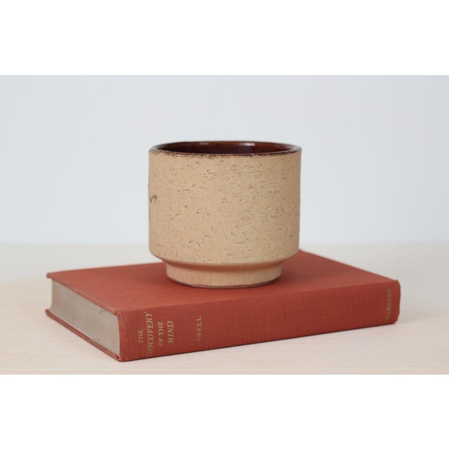 1970s West German pottery piece featuring an earthy cork-textured stoneware exterior with a deep brown glazed interior....
