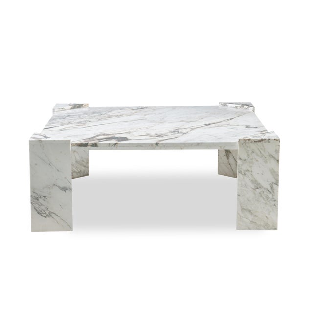 The midcentury-inspired grand scale Honed Calcatta Paonazzo marble cocktail table with minimalist triangular legs reflects...