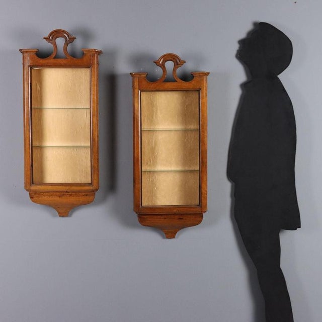 Pair of walnut display cases. Perforated top, velvet interior, two glass shelves. Italy, mid-19th century. This piece is...
