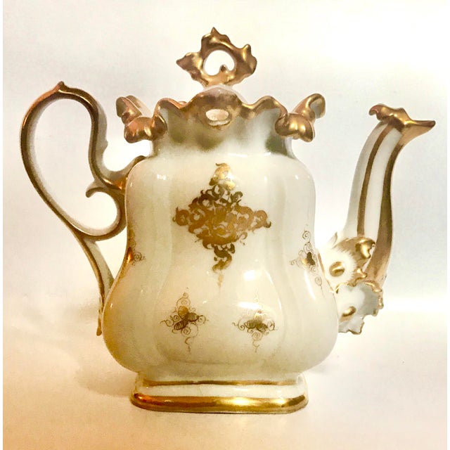 19th Century Rococo coffeepot in style of Meissen or Limoges. Unbelievable condition for its age. The gold gild is...
