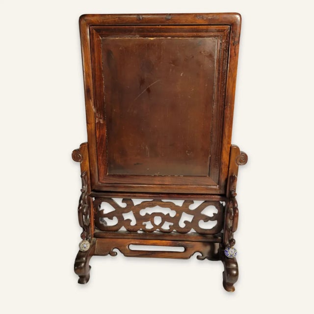 This is an unusual Chinese decorated wood tile tabletop screen mounted in an intricately carved framework. The decoration...