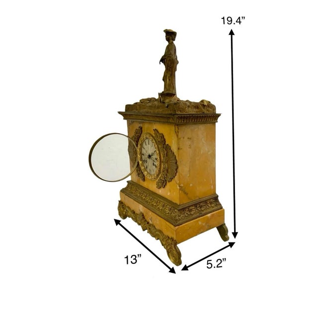 An antique French style clock made of marble with brass accents. This decorative piece features a marble frame and brass...