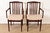 A sleek and stylish pair of mid-century Danish Modern sculpted rosewood armchairs or dining captain chairs By Vamdrup...
