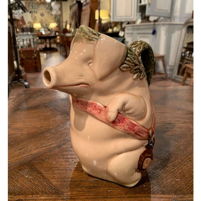 This colorful, antique water pitcher was crafted in Northern France, circa 1880. The jug, titled "Cochon au Jambon" (pig...