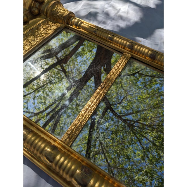 Antique turned pinewood with its original gilt surface and mercury amalgam mirror. The cornice is fitted with 12 gilt...