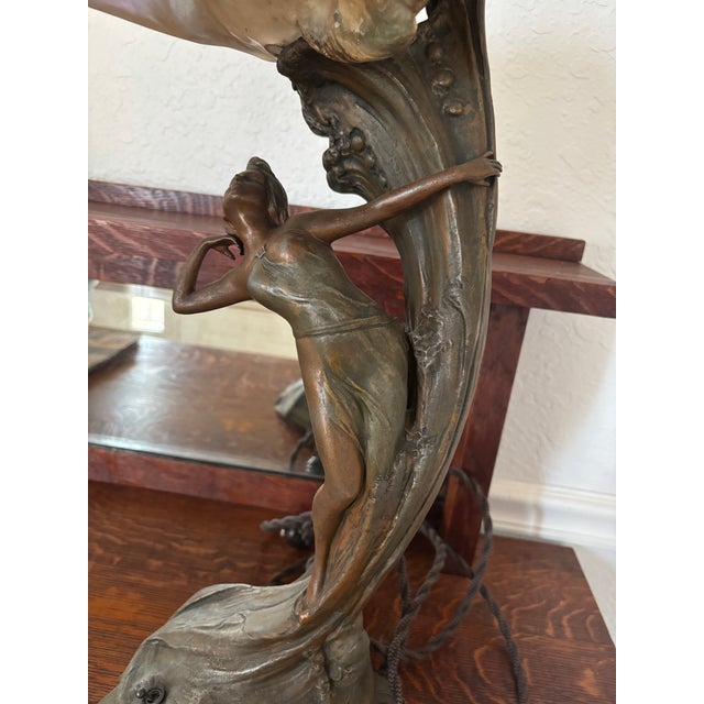 This exquisite Art Nouveau lamp showcases a mermaid alongside a genuine conch shell. The base, crafted from solid metal,...