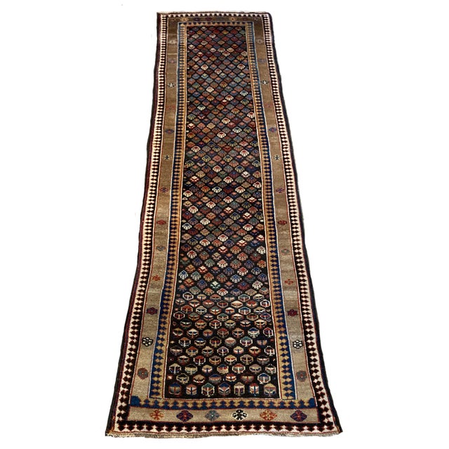 A fabulous antique Kurdish runner, hand woven circa 1900. The design features an all over geometrical design on a deep...