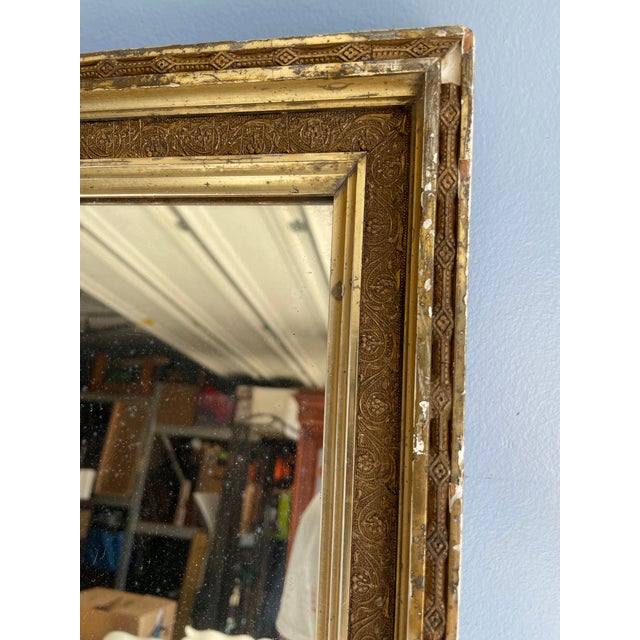 Antique Gilt Wood Mirror with Black Edge Detail Elegant antique gilt wood frame mirror featuring a sleek black edge accent...