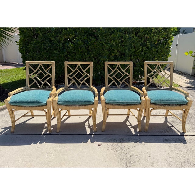 Vintage Lane Venture rattan dining chairs featuring distinctive open sculptural fretwork backs with gently curved rattan...