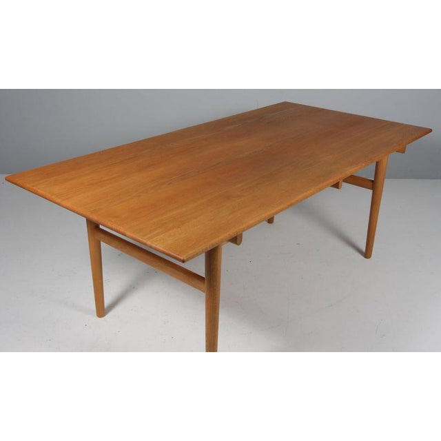 Hans J. Wegner dining table made of solid oiled oak, two extension leaf Base of solid oak Model CH327, made by Carl...