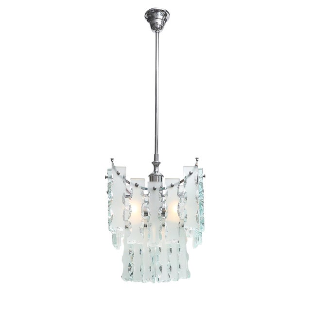 This Mid-Century Modernist geometric knapped glass pendant chandelier, in the style of Fontana Arte and crafted in Italy...