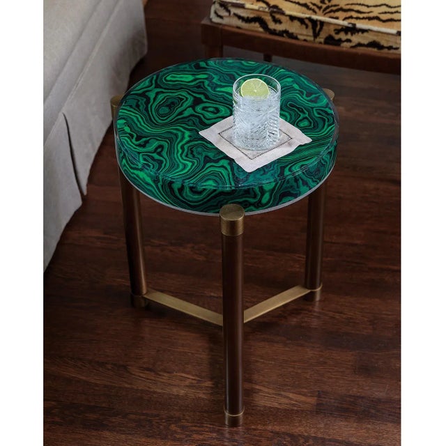 Dramatic green malachite and burnished aged brass is featured on our tri-leg round accent table. Scaled as a lamp or drink...