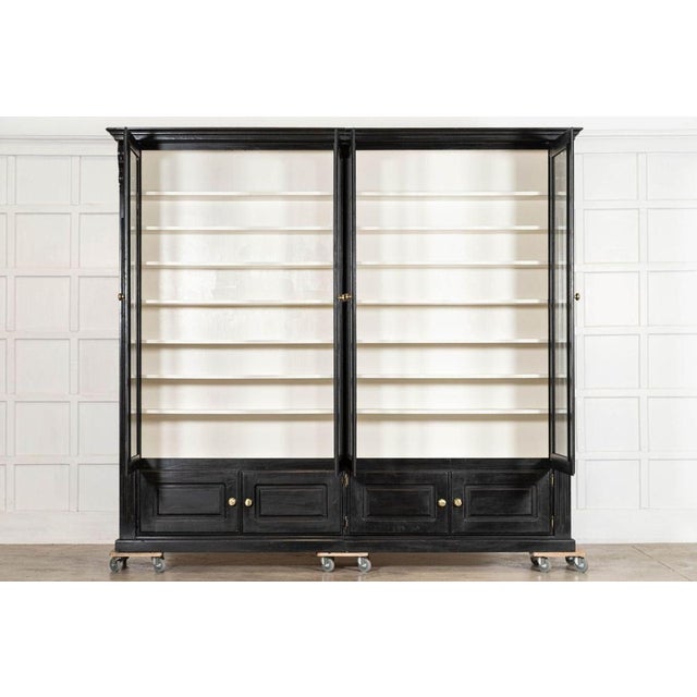 Circa 1940 Monumental English Ebonised Mahogany Glazed Bookcase W262 x D42.5 x H233.5 cm (Splits into two sections) Top...
