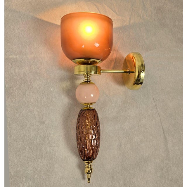 Pair of mid-century modern glass, Murano glass wall sconces, Italy circa 1990s. The pair of Italian sconces is made of...