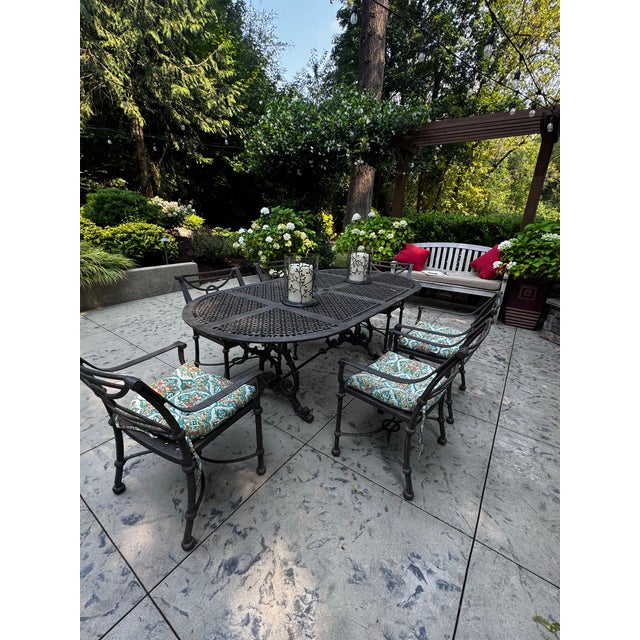 Beautiful vintage cast aluminum outdoor dining set featuring a generously sized 84-inch oval dining table and six matching...