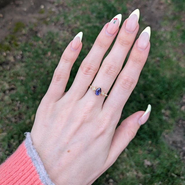 A refined statement of color and elegance, this ring features a 1.1Ct purple sapphire with a rich, captivating hue,...