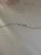 Vintage original oil painting depicting a majestic tall sailing ship under full sail, navigating vibrant blue waters...