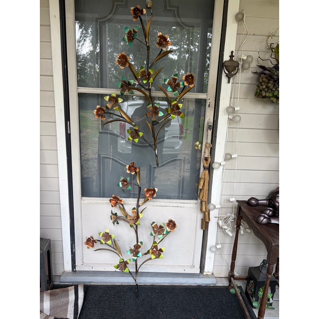 Set of 2 metal wall decor Sculptures in a floral and long leaf design motif. Multi colors in a warm copper, green, and...