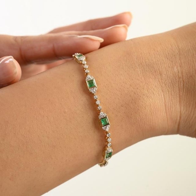 This Art Deco-style link bracelet features 10 square cut emeralds totaling 1.36 carats, set in rich 14k yellow gold. each...
