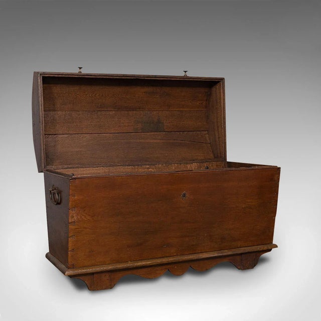 This is a large antique shipping chest. An English, oak carriage trunk, dating to the late 18th century Georgian period,...
