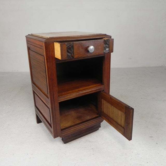 This solid oak cabinet features a top drawer, an open middle compartment, and a lower cabinet with a door. There are some...