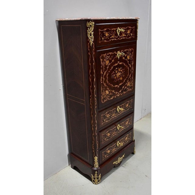 Small Louis XIV style secretary, in various wood marquetries. Its upper is a marble of the Pyrenees predominantly salmon,...