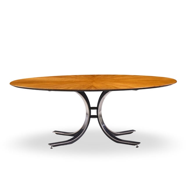Osvaldo Borsani for Stow & Davis Mid Century Starburst Walnut and Steel Oval Dining Table This dining table measures: 78.5...